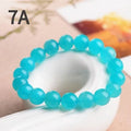 Polished Amazonite scattered beads in ice colour with size options for jewellery making next to crystal bracelet