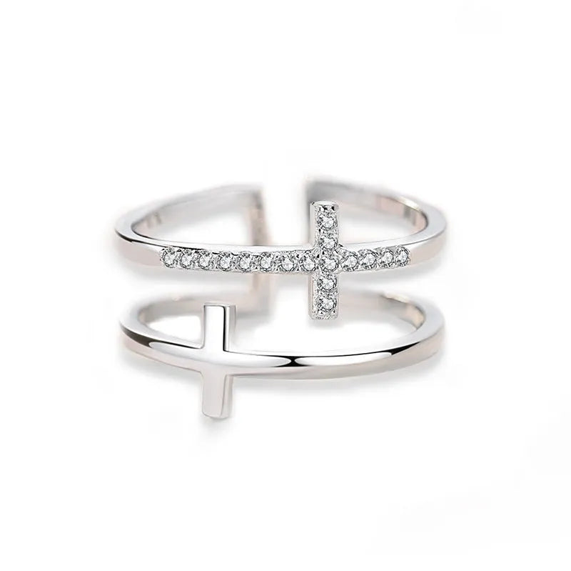 Adjustable double cross geometric ring in copper with cubic zirconia stones, shown in a gold colour finish.