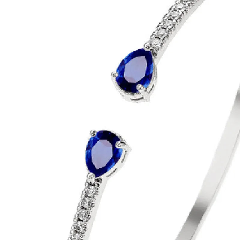 Copper bracelet with inlaid zircon detailing in simple style, shown in white and blue colour options.