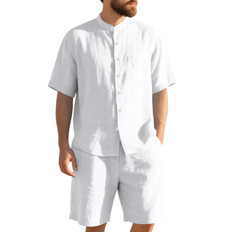 Men's light blue linen two-piece suit with Henry collar, short sleeves, and matching shorts for summer wear