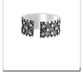 Adjustable sterling silver ring with a raised five-pointed star design on the band.