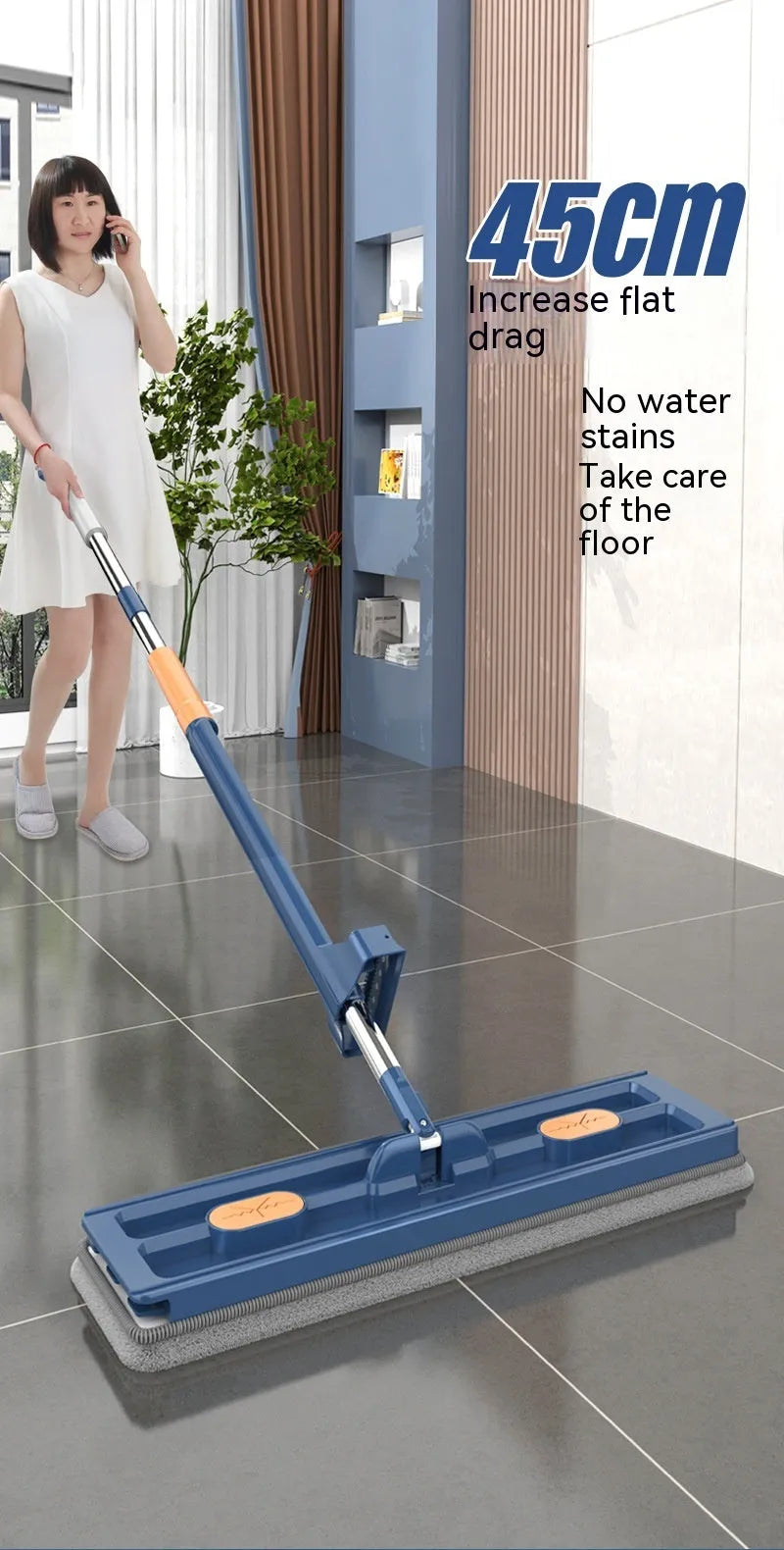 Large flat mop with long stainless steel handle and blue rotating mop head on a wooden floor.