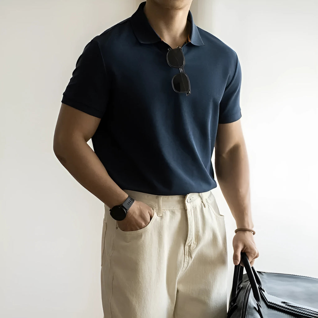 Men's short-sleeved blue polo shirt with a placket and collar, laid flat.