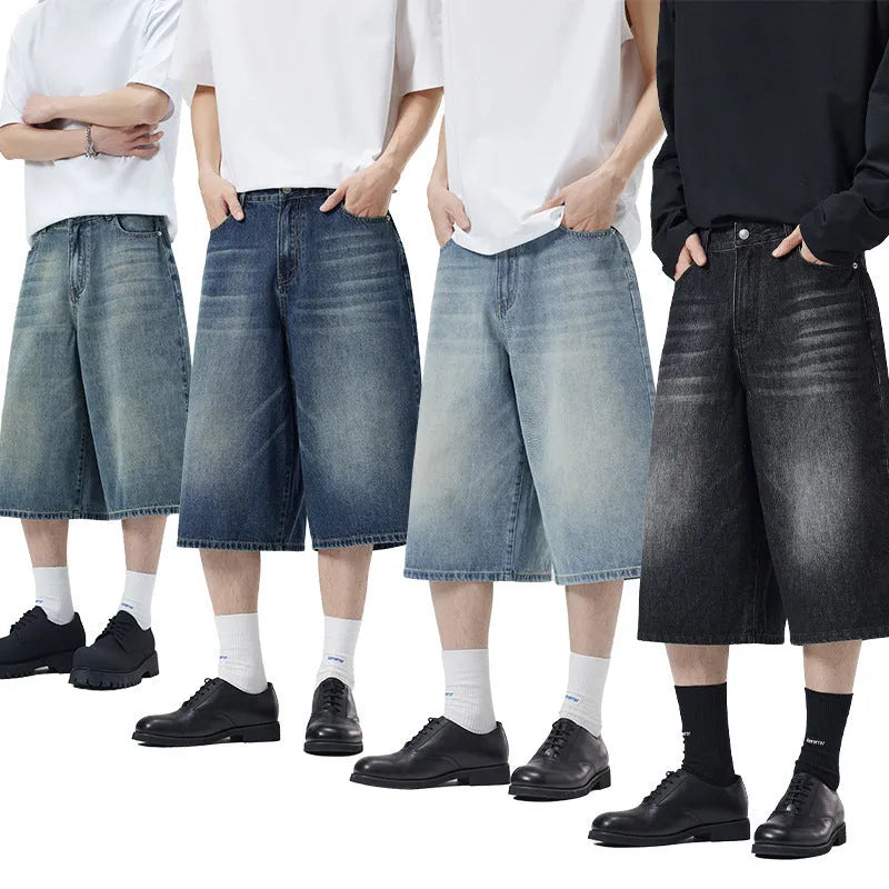 Man wearing loose straight-leg cotton denim shorts in a summer casual setting.