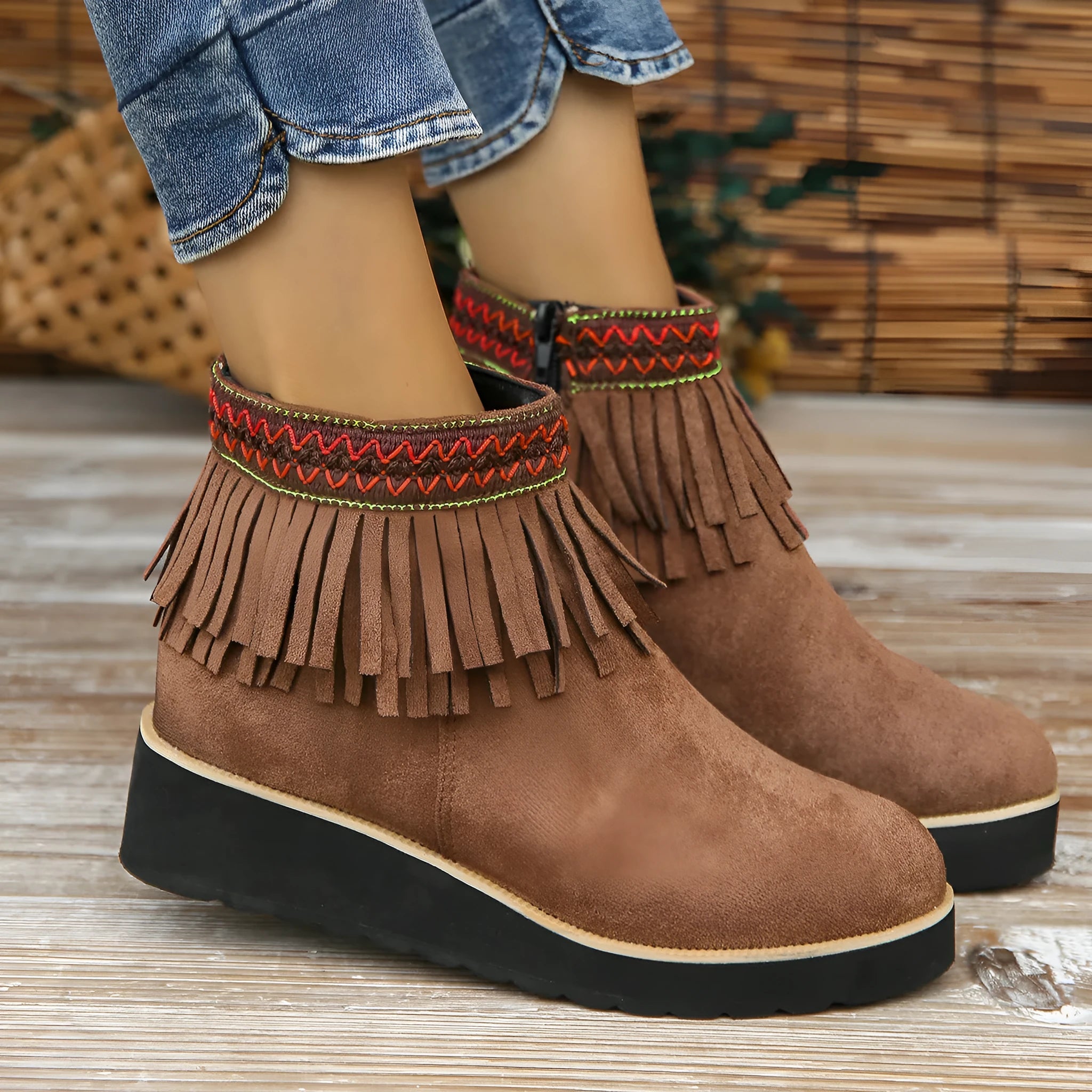 Women's suede wedge ankle boots in dark brown with a side zipper and tassel detail.