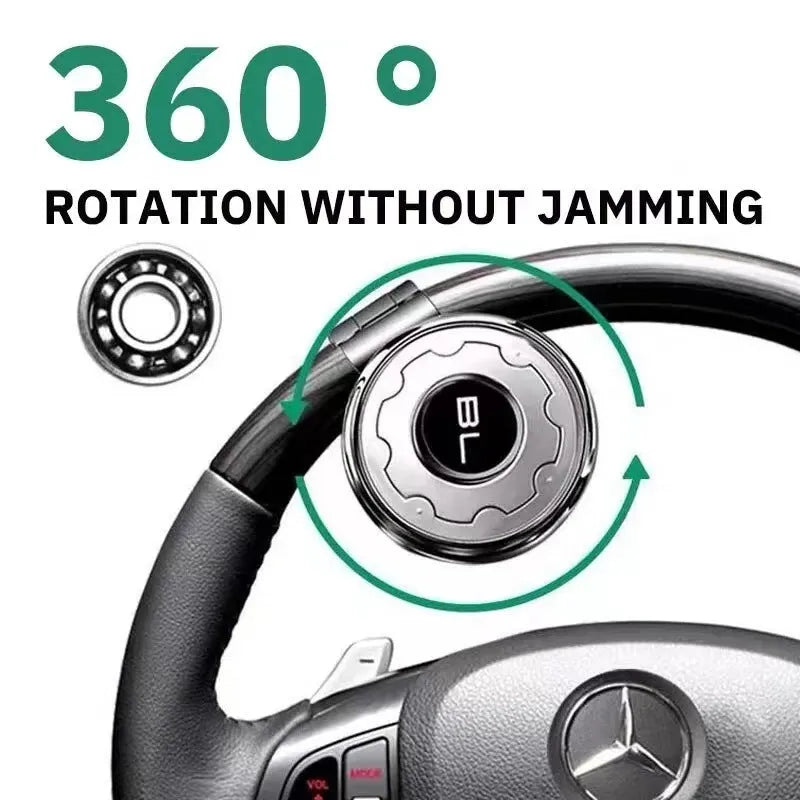 Metal universal steering wheel assist ball with steel ball bearing in silver finish mounted on a car steering wheel for one-handed control