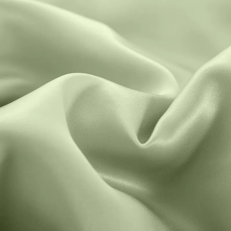 Double-sided solid colour silk duvet cover shown in Lotus Pink, pea green, bright brown, purple, white, or blue.