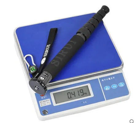 Black carbon fibre telescoping camera monopod extended to its full height.