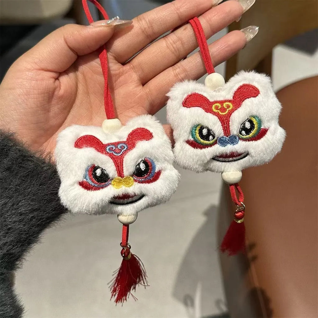 Blue and yellow Chinese style cartoon plush lion keychain ornaments with tassels and a star stone.