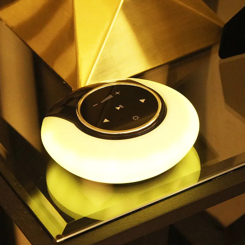 Blue Bluetooth desk lamp with speaker, shown folded, with touch controls on a white base.