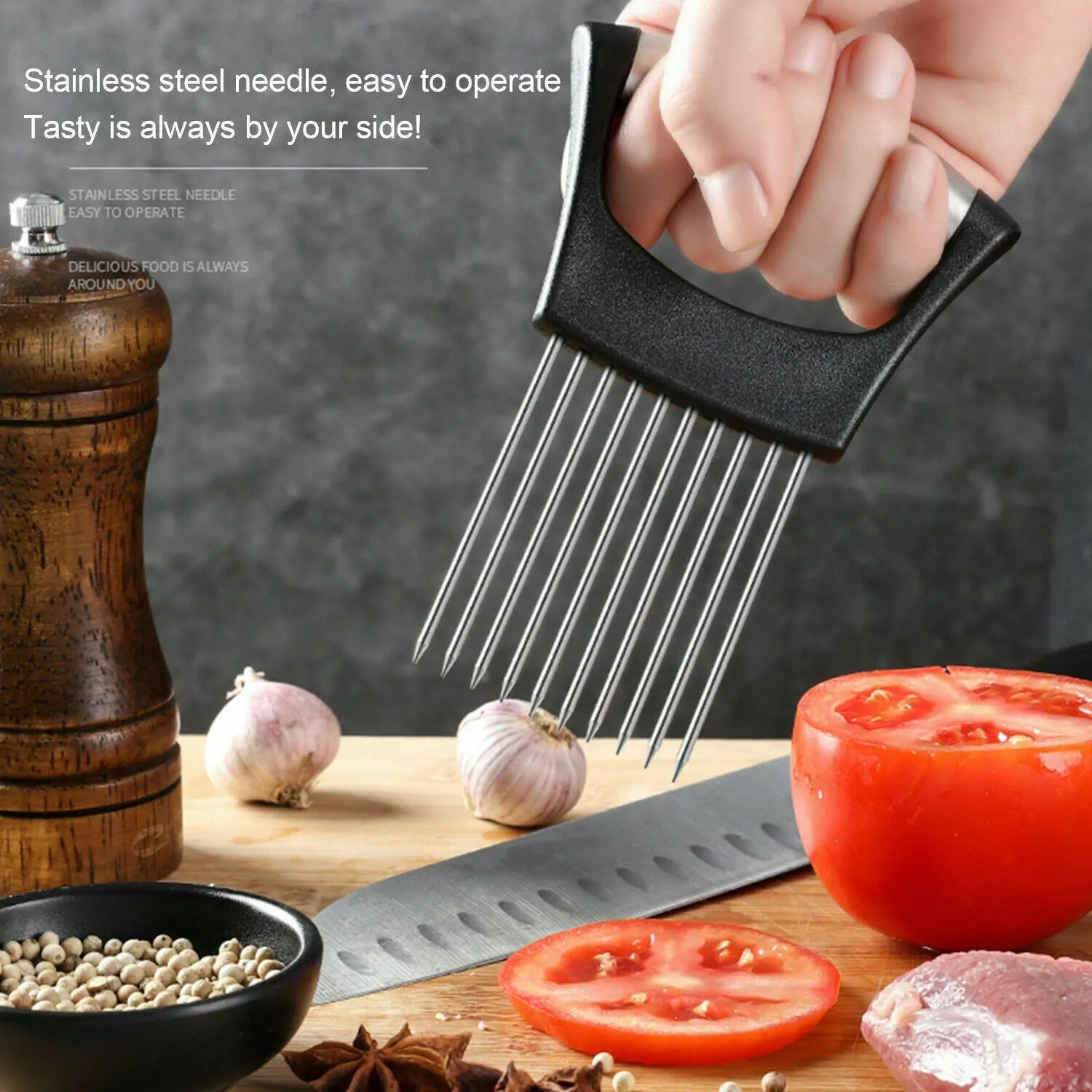 Stainless steel onion holder slicer with non-slip base on a kitchen counter, holding a tomato for slicing