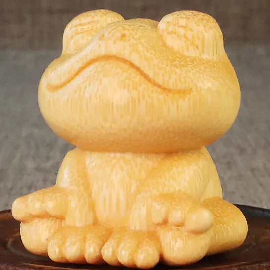 Solid bamboo smiling frog carving ornament measuring 5cm height with cartoon design