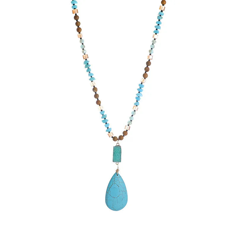Long blue turquoise imitation mineral pendant necklace with a geometric setting on a ball bead chain.