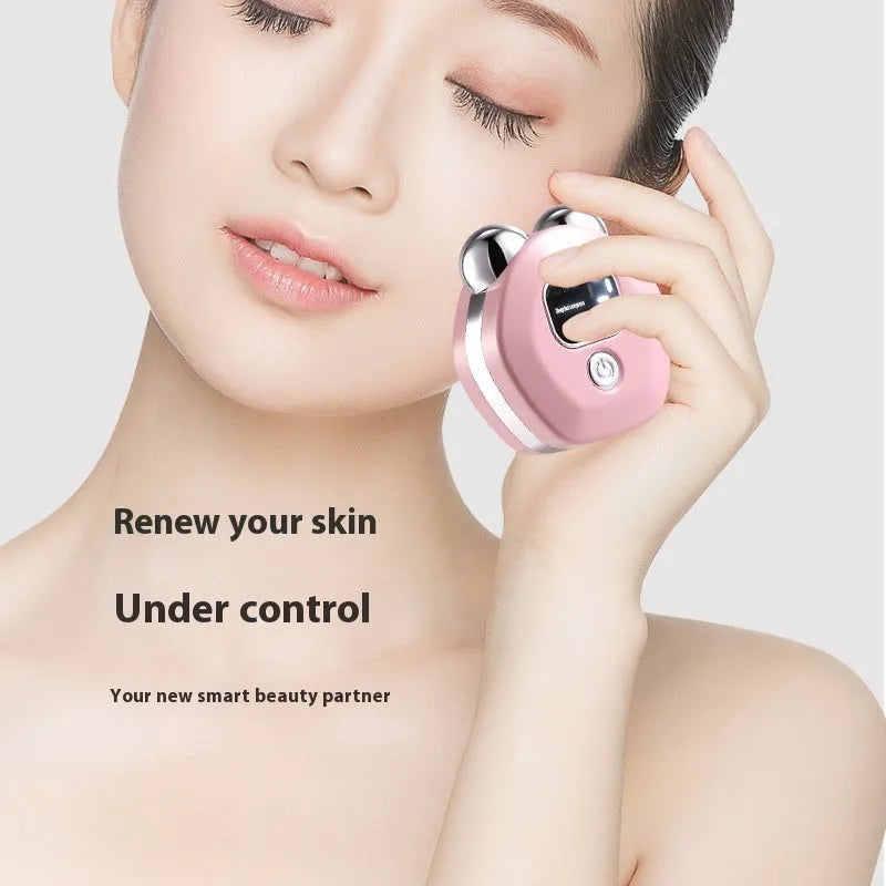 Portable white facial massage instrument with double-roller head for hot compress and micro current therapy.