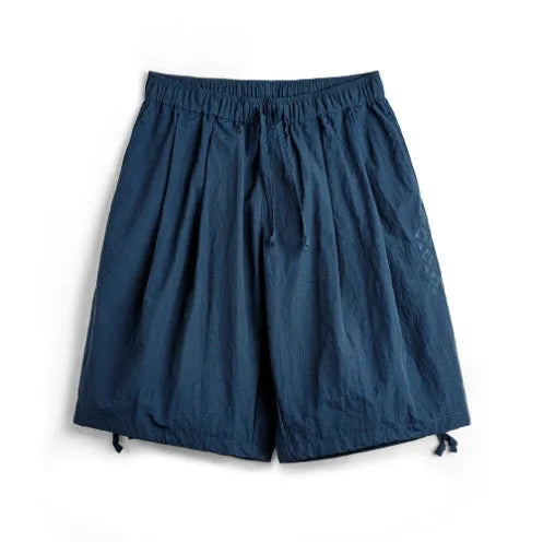 Men's Prussian blue nylon beach shorts with embroidered detail and elastic waistband