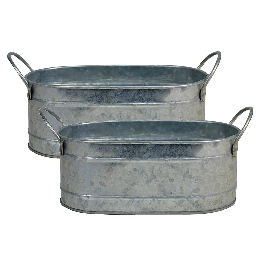 Galvanised iron succulent flowerpot with rustic finish on a wooden desk.