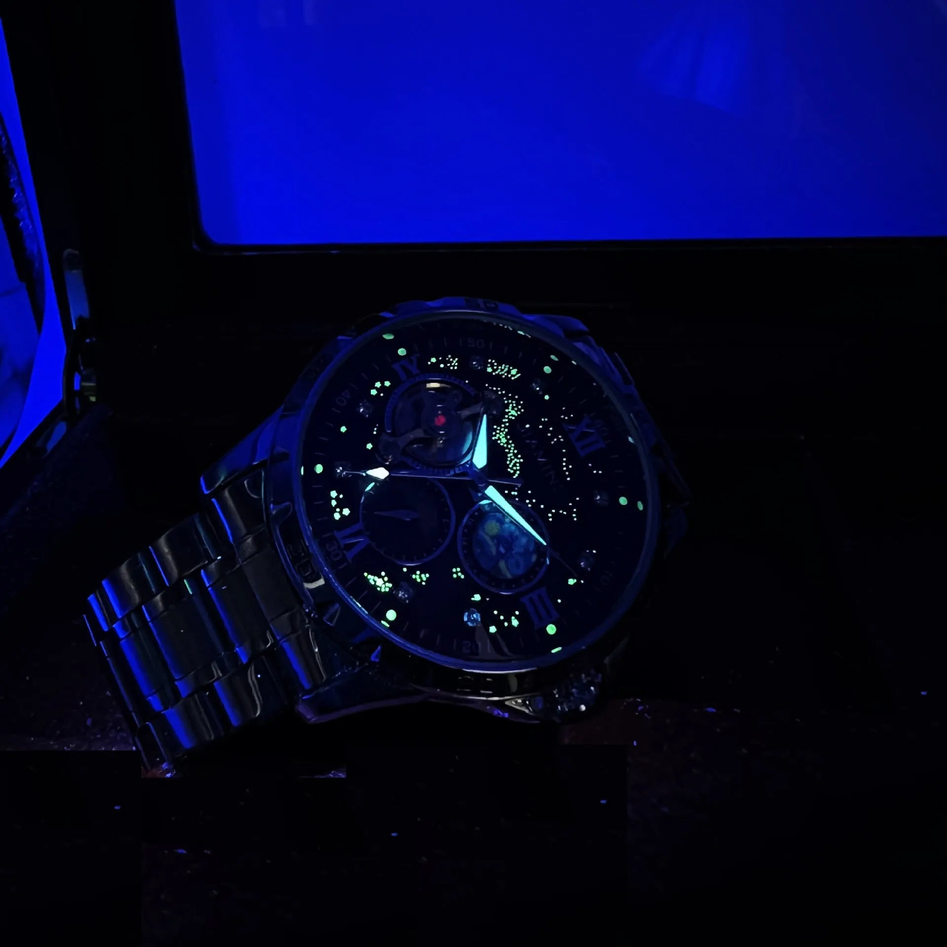 Men's rose gold automatic mechanical watch with black dial and 12mm thick case.