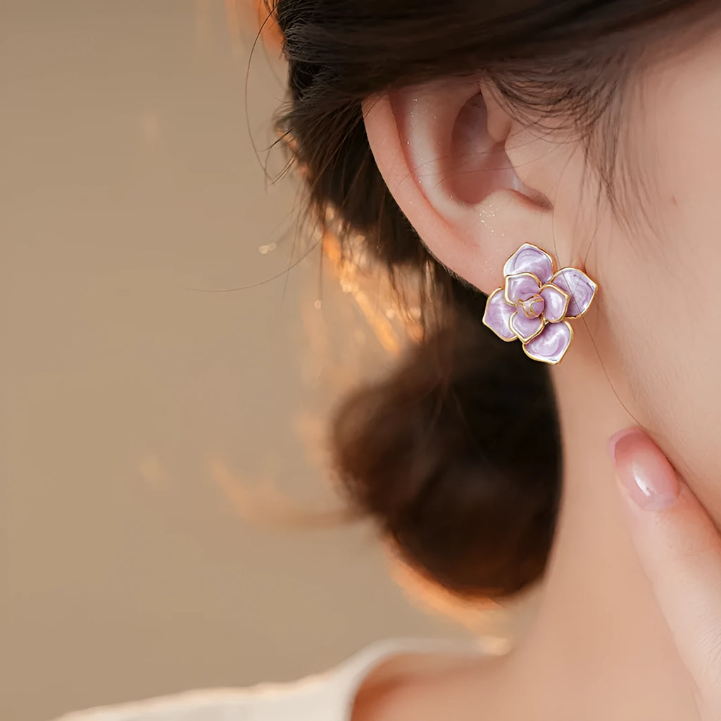 Gold plated purple oil-spot glaze flower stud earrings made from copper on a silver needle post.