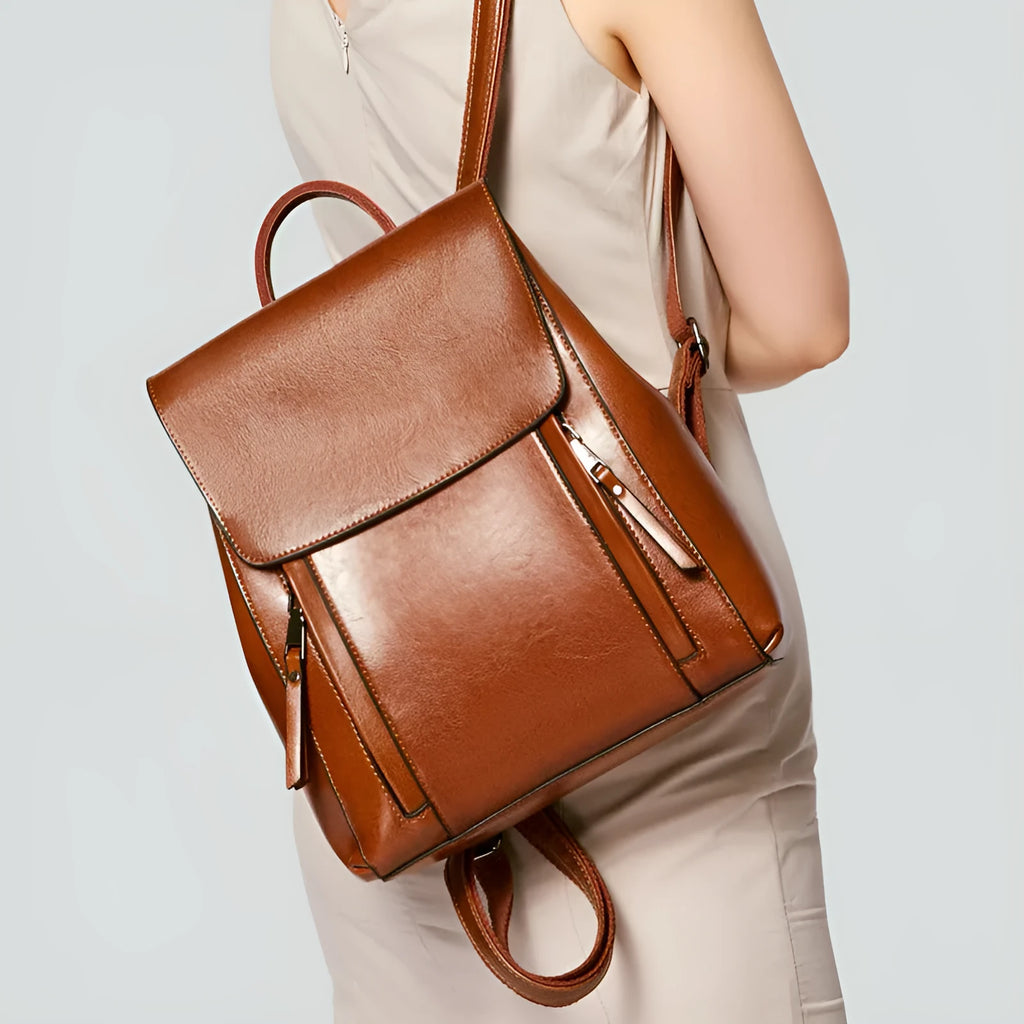 Large black genuine leather women's backpack with double straps and stitching detail.