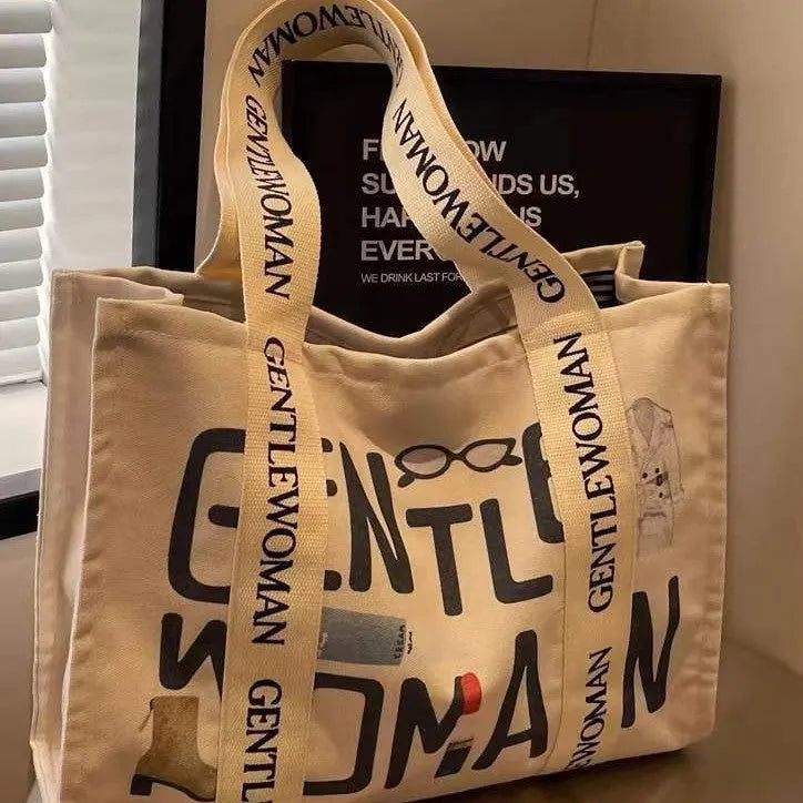 Large canvas shoulder tote bag with printed design, shown in available colour and pattern options.