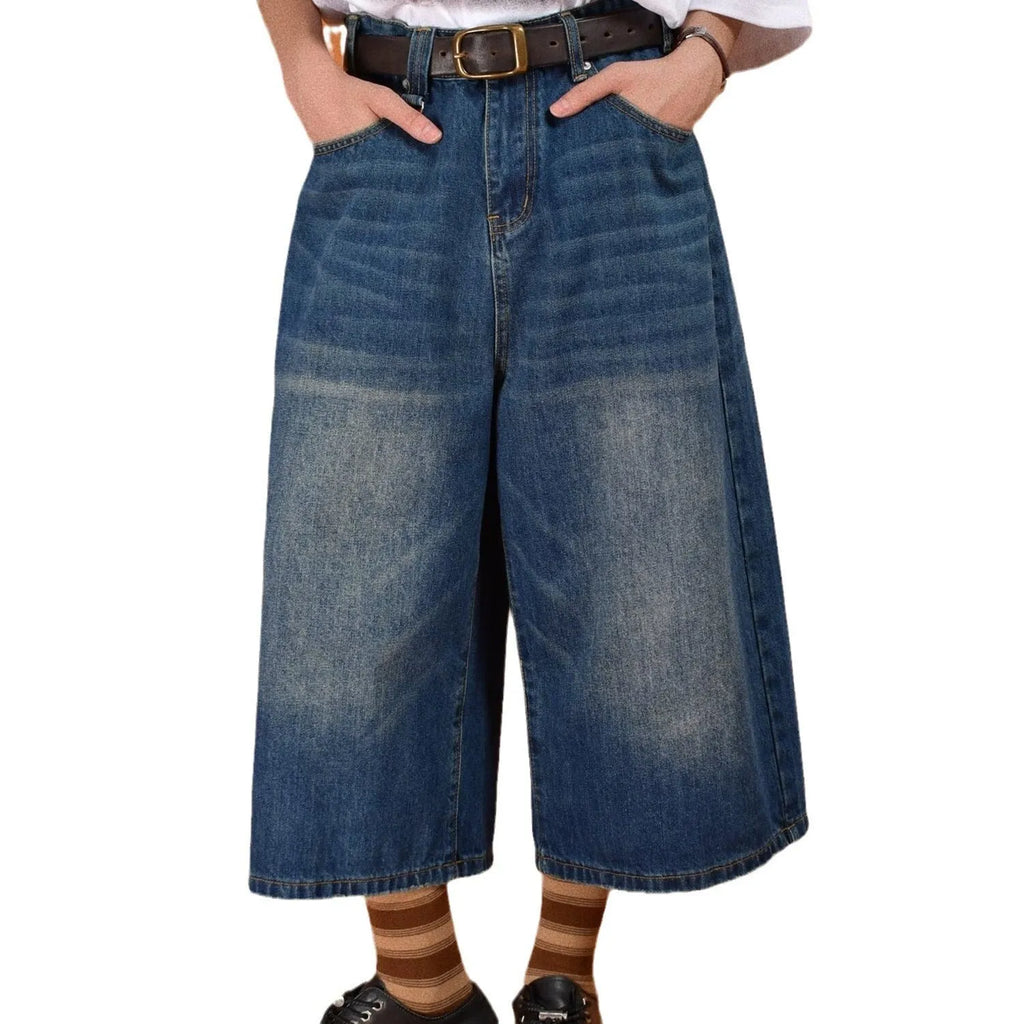 Men's loose-fit straight-leg denim shorts in blue, shown on a hanger.