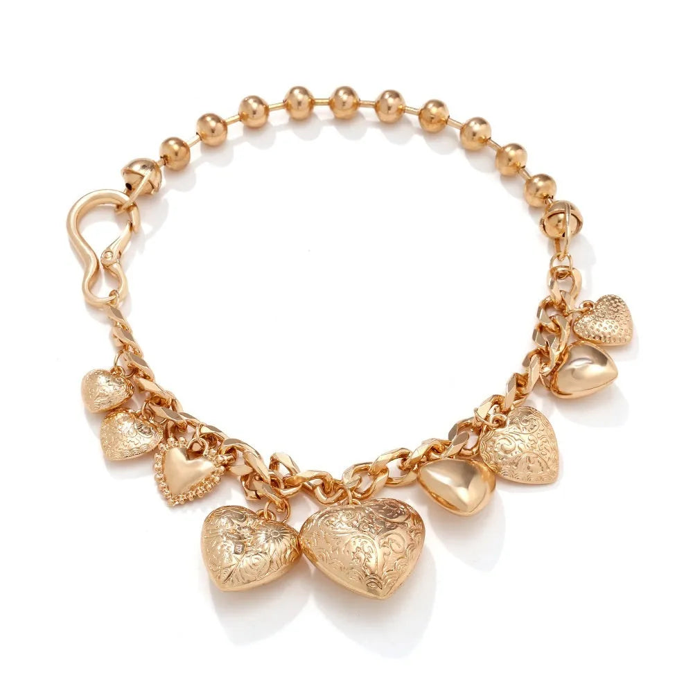 Gold carved heart pendant necklace with adjustable chain on white background