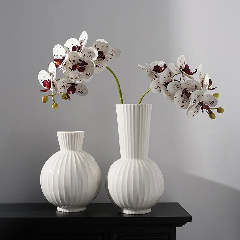 White ceramic ball vase with stripes, American country style, shown on a table.