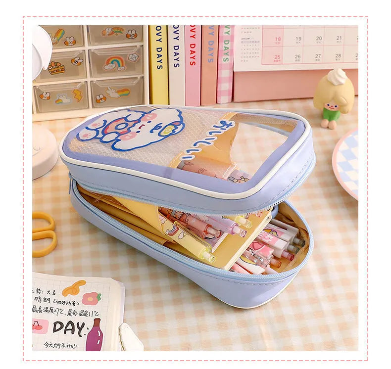 Transparent PVC pencil case with cartoon designs measuring 22cm length for school stationery organisation