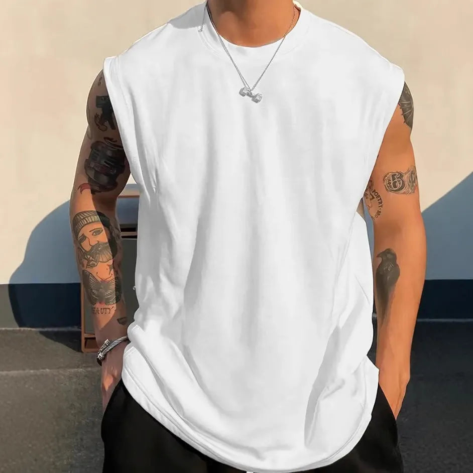 A man's loose grey cotton sleeveless t-shirt on a hanger, showing the straight hem and pullover design.