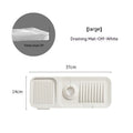 Silicone faucet pad in beige with sloped dual drains, sitting around a kitchen tap