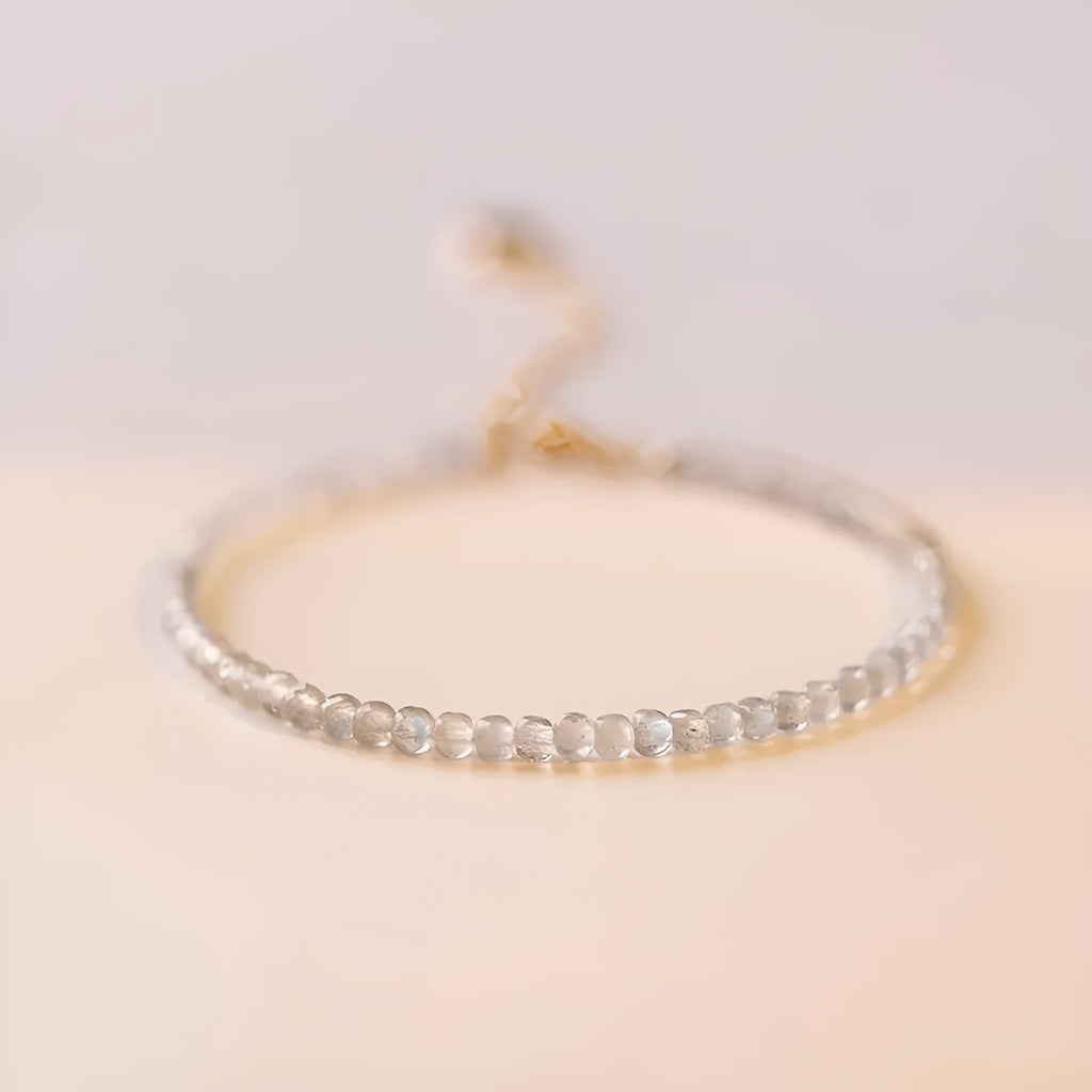 Natural gray moonstone diamond-shaped beads on a silver bracelet with clasp
