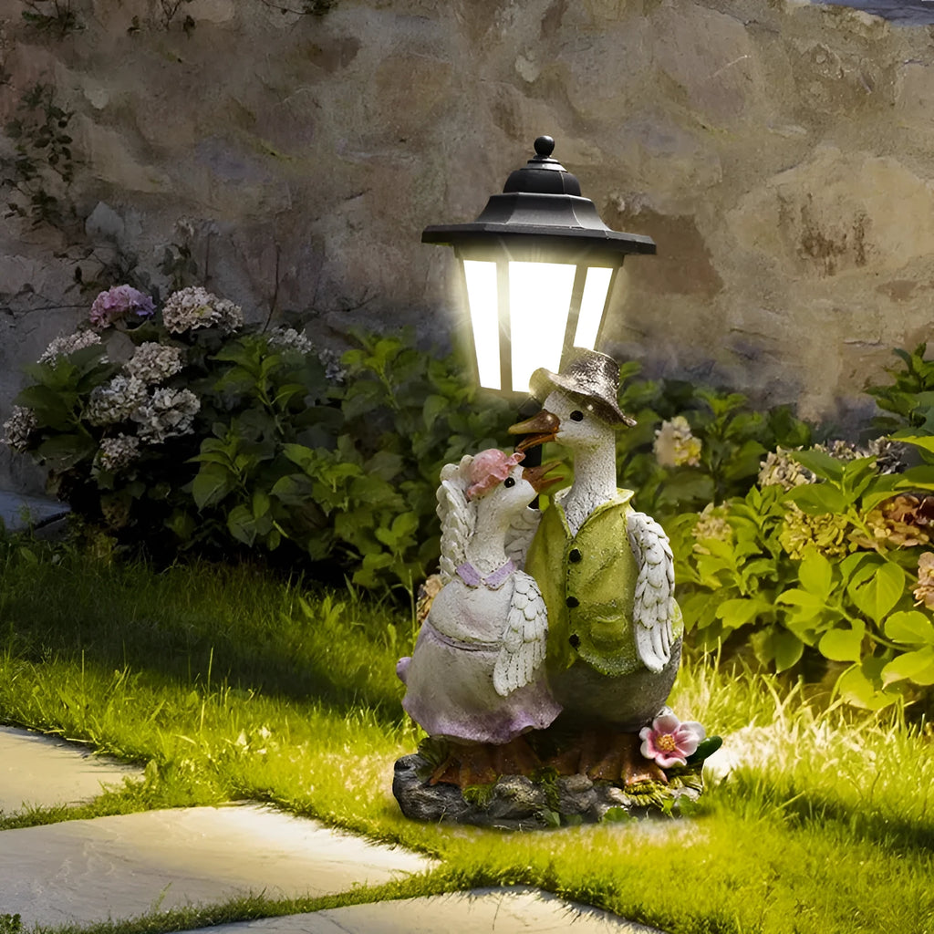 Decorative hexagonal solar garden lamp with animal sculpture design on patio.