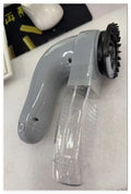 Grey portable electric pet hair remover brush with soft rubber head for grooming dogs and cats.