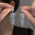 Silver pagoda-shaped Christmas tree drop earrings with sparkling zircon stones
