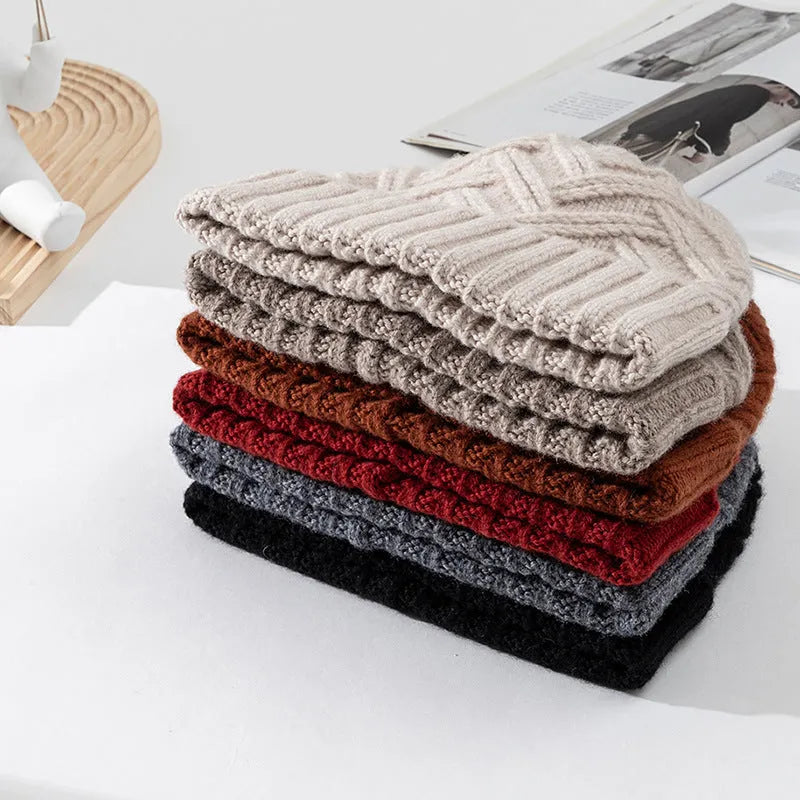 Women's wool knitted dome hat in various colours showing textured knit pattern and totem design elements