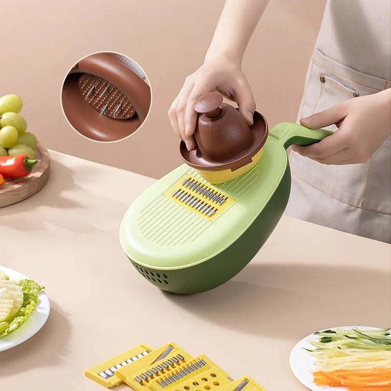 Vegetable grater slicer with six sabres and bottom storage box in avocado green colour on a kitchen counter