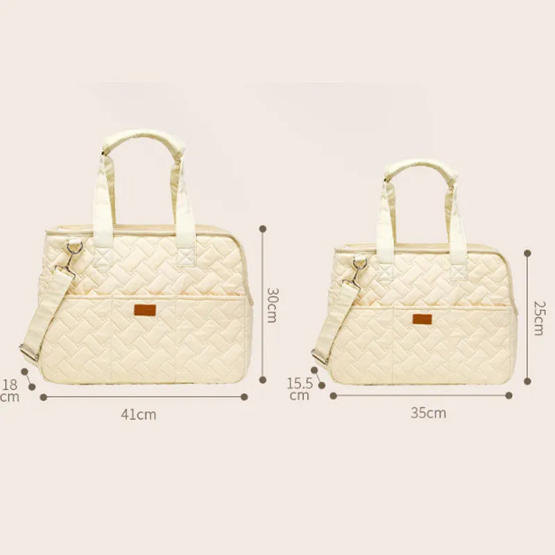Grey pet carrier handbag with mesh panels and a safety tether for a small dog.