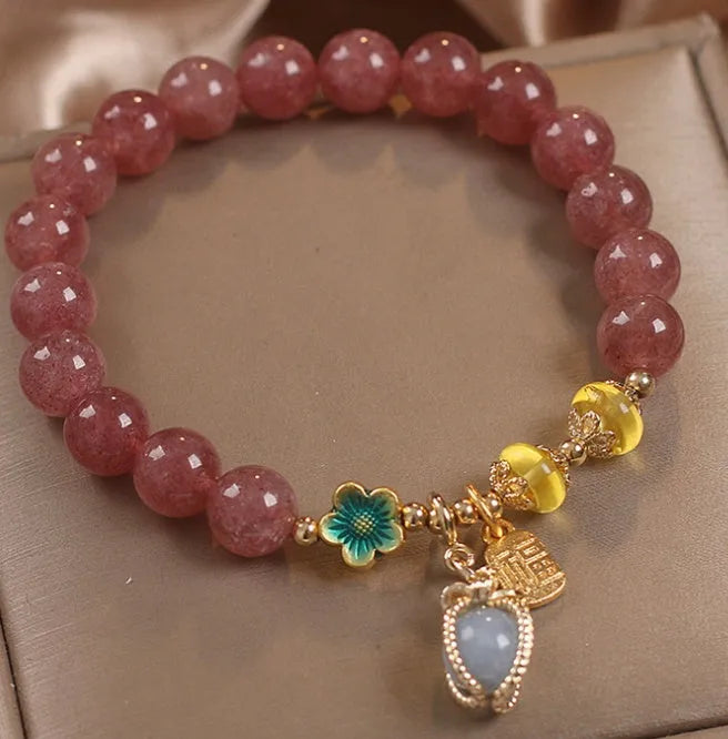 Natural Strawberry Quartz beaded bracelet with rhinestone accents on red alloy base