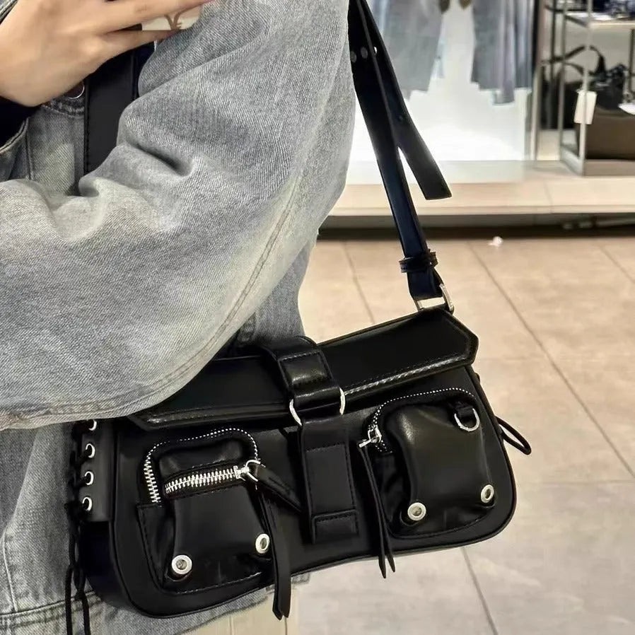 Black underarm baguette messenger bag with adjustable shoulder strap showing structured design