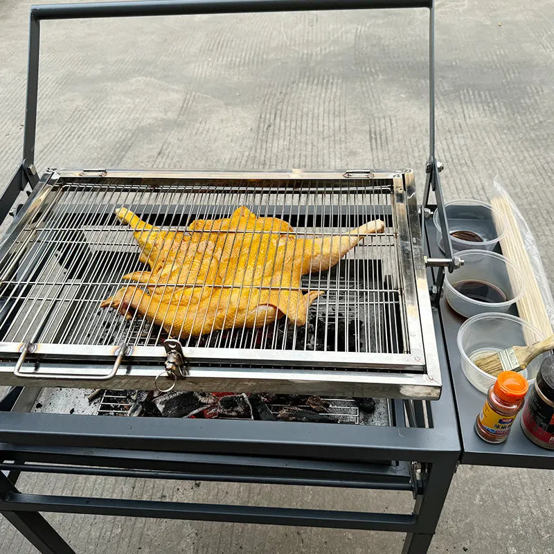Foldable large charcoal barbecue grill shown in a garden setting