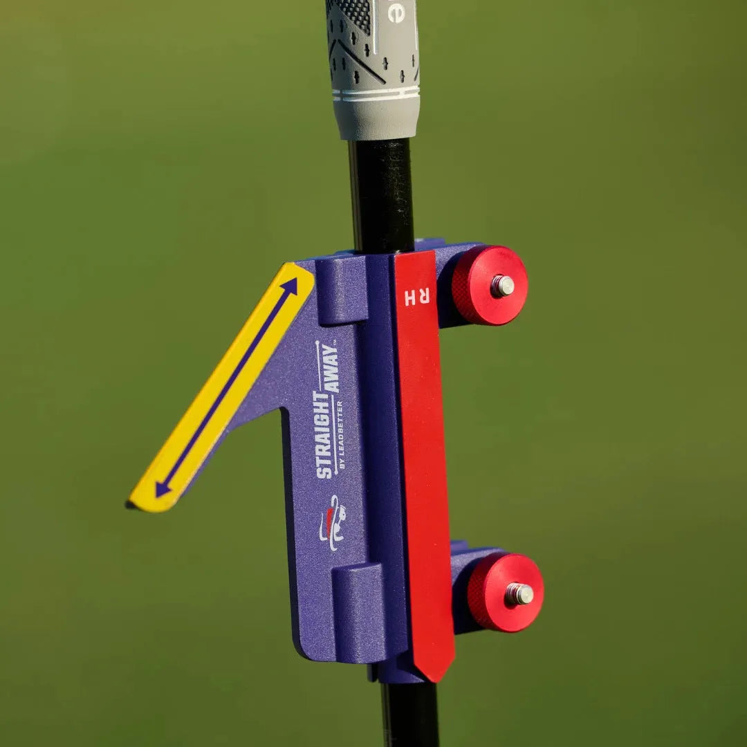 Plastic golf swing plane training aid simulator on a green background.