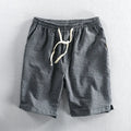 Men's striped casual loose straight shorts in cotton fabric on a hanger