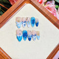 Blue hand-painted carved false nails in summer ice colour with transparent finish