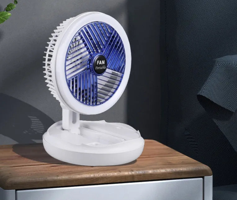 Blue USB foldable table fan with LED night light, pen holder, and four speed settings on a desk