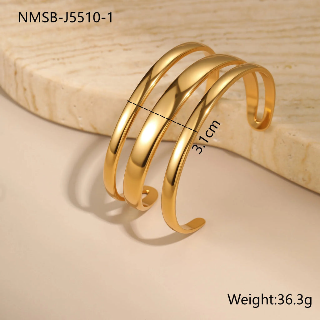 Stainless steel opening bracelet for women in gold or steel finish with geometric line design