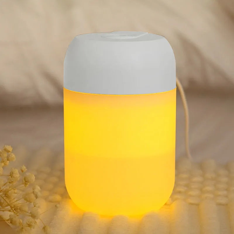 Small white cylindrical USB humidifier with charging cable on table