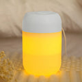 Small white cylindrical USB humidifier with charging cable on table