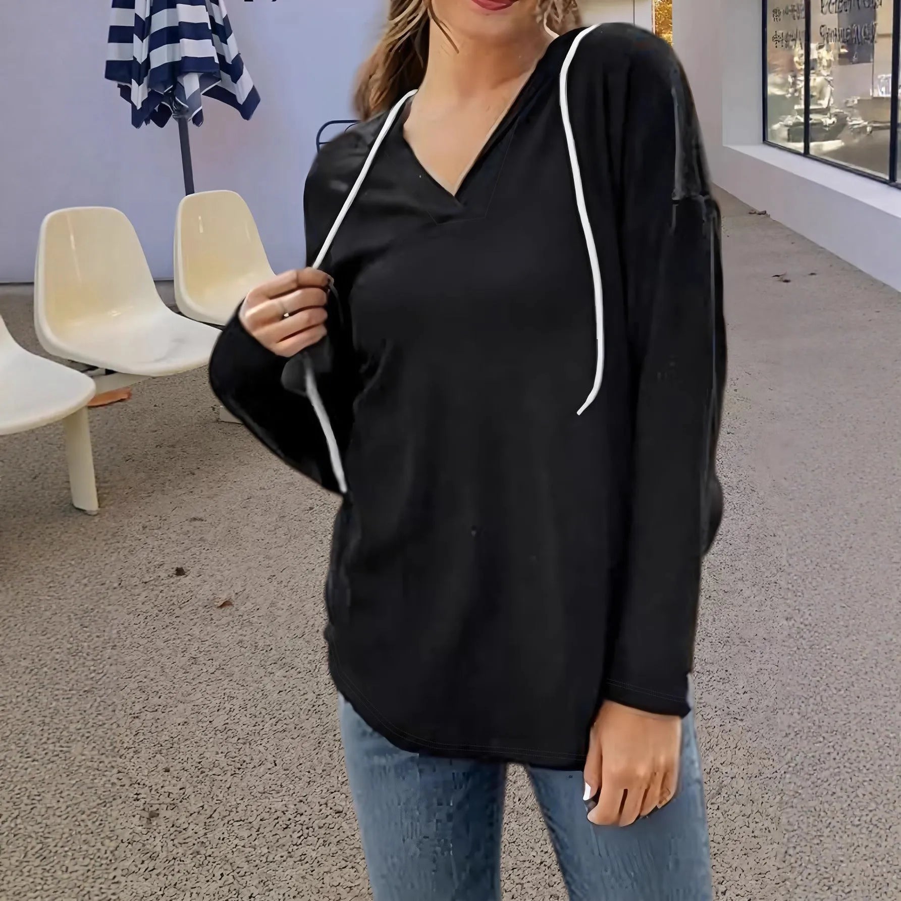 Women's red V-neck hooded sweatshirt showing front view with loose fit and regular sleeves