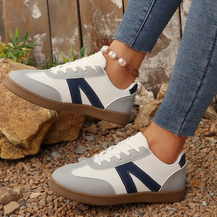 Women's blue flat German training hiking shoes with rubber sole and artificial PU upper, low-top lace-up style on neutral background