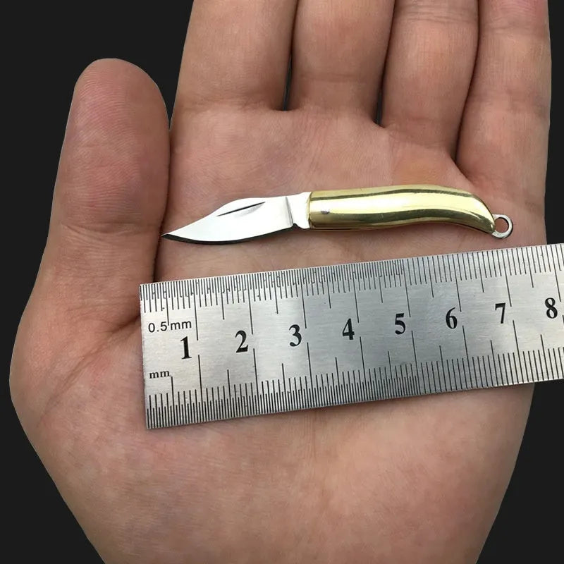 Brass mini folding knife with 3cm blade and keychain pendant on brass ring, 50mm full length model shown